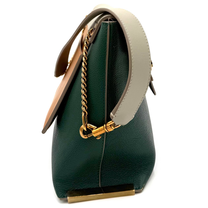 A dark green leather handbag with a light beige shoulder strap and gold-tone hardware, shown from a side profile view against a white background.