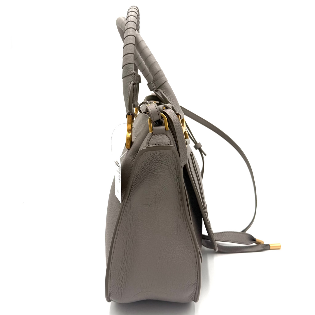 A taupe leather shoulder bag with a textured, twisted top handle and gold-tone hardware, shown from a side profile view on a white background.