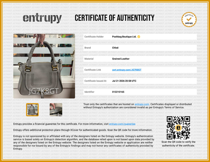 A certificate of authenticity document for a Clued leather handbag by Entrupy, featuring a photo of the gray and gold handbag, product details in a table, a QR code, and a gold certification seal.