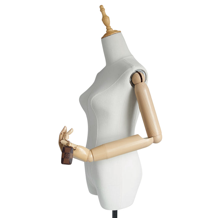 A white female dress form mannequin with articulated wooden arms and a wooden neck cap, shown against a plain white background.