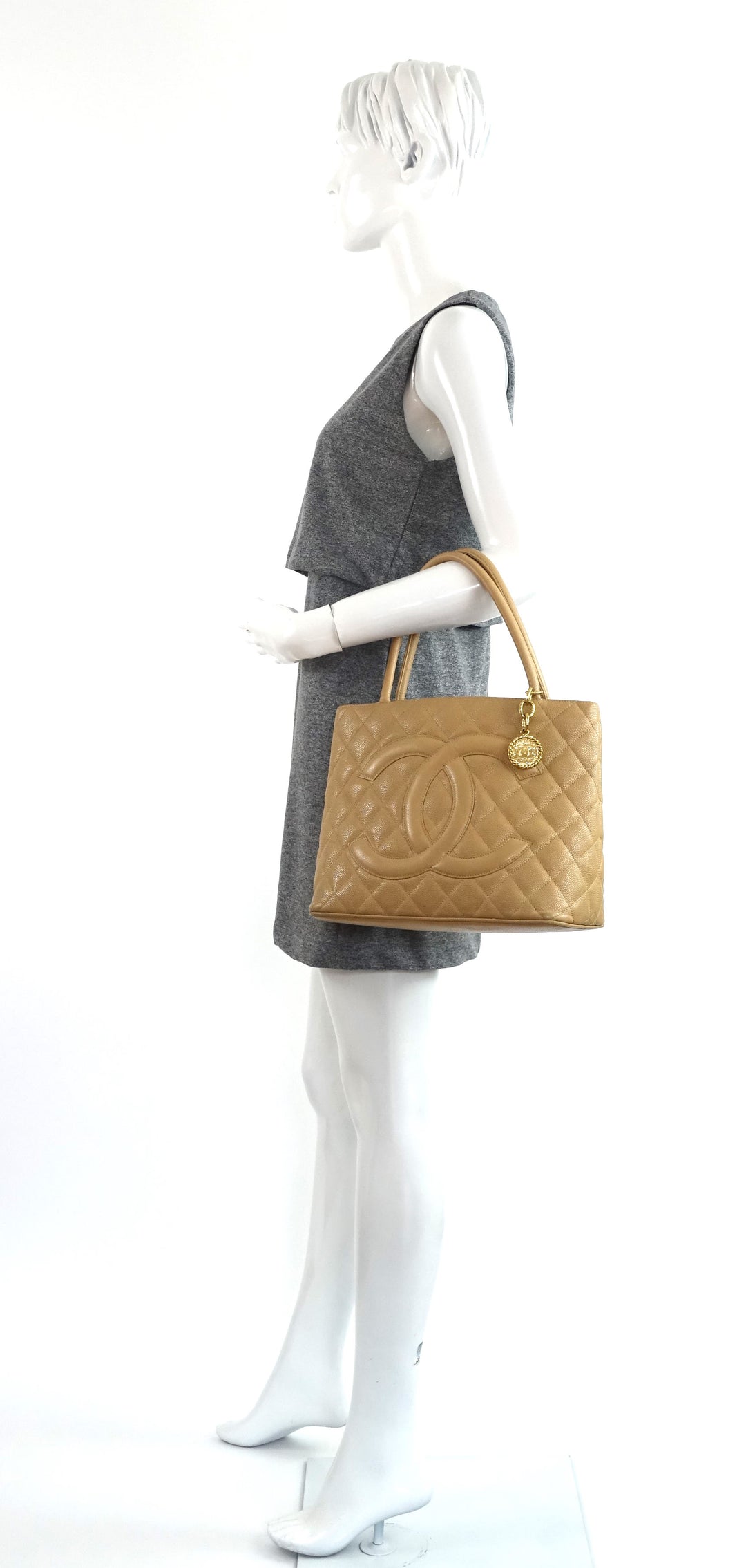 quilted caviar leather suspended medallion tote bag