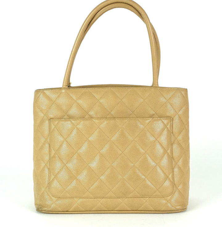quilted caviar leather suspended medallion tote bag