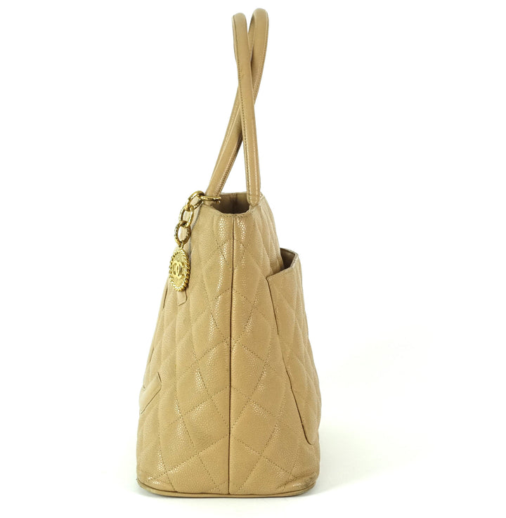 quilted caviar leather suspended medallion tote bag