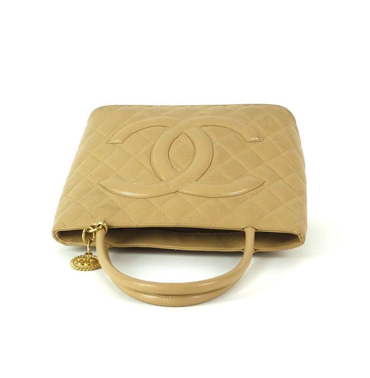 quilted caviar leather suspended medallion tote bag